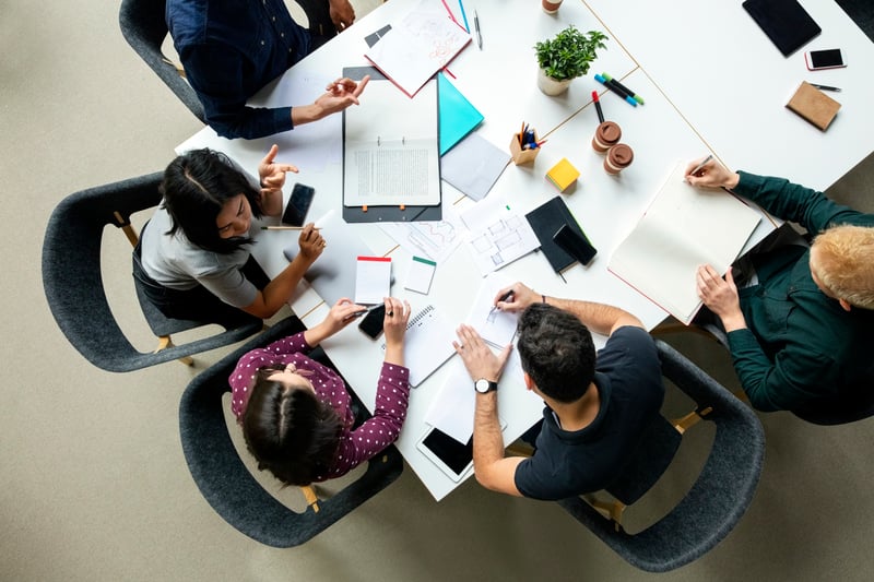 birdseye-view-people-at-desk