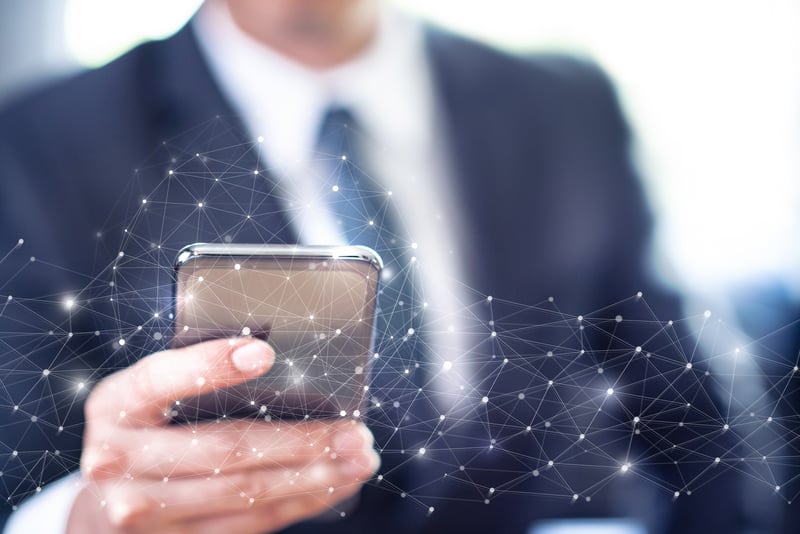 Man in suit using a smartphone