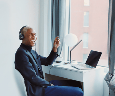 Smiling young man wearing headset working from home