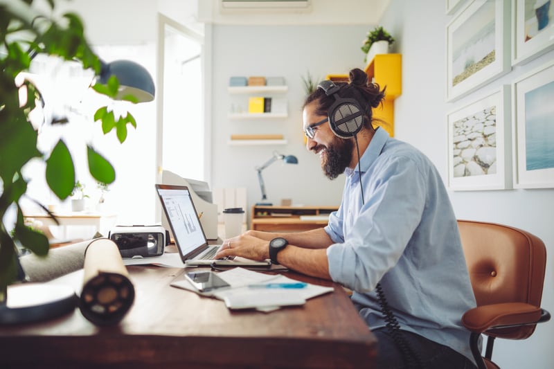 Young man with beard working from home