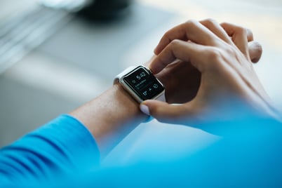 Close up of young man checking Apple watch