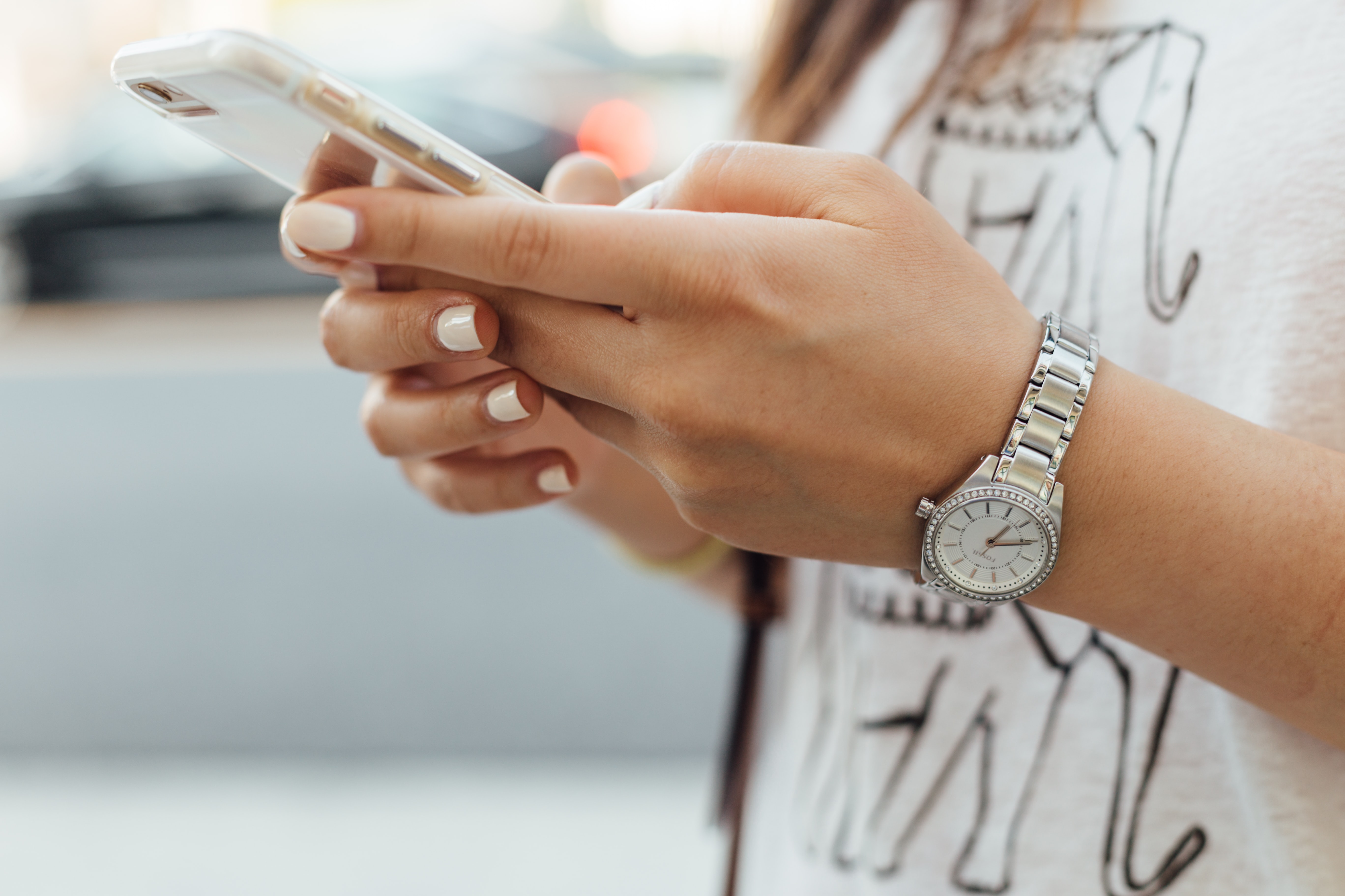 Close up of young woman's hands holding smart phone