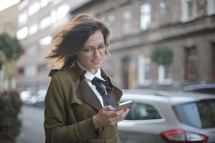 Adult female using smartphone on street