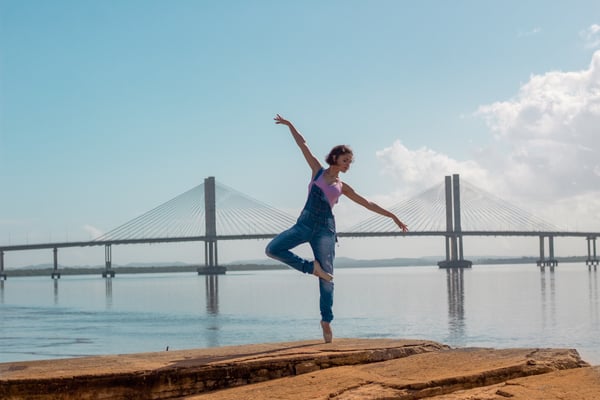 Woman on rock formation doing yoga