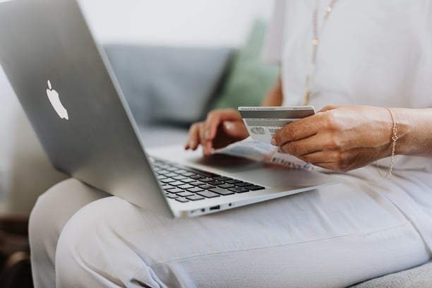 Close up of woman with laptop and credit card