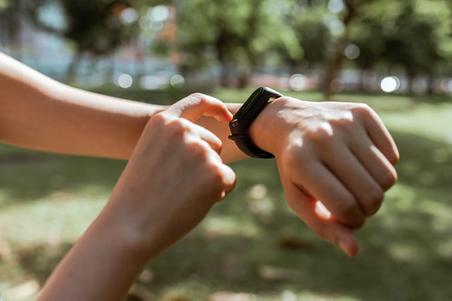 Close up of hands checking activity tracker