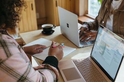 Two women working at laptops