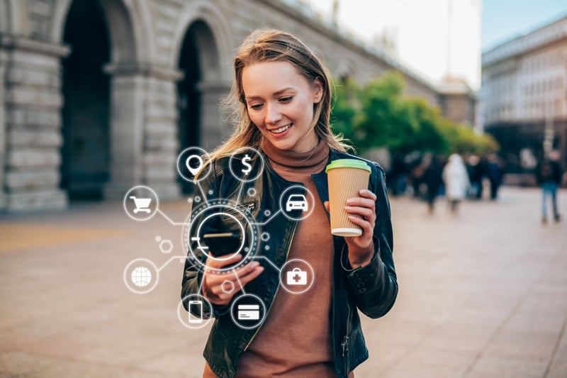 young woman using a smartphone with various icons of smart technology